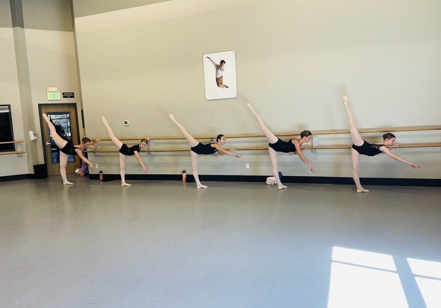 ballerinas practicing arabesque in a ballet class