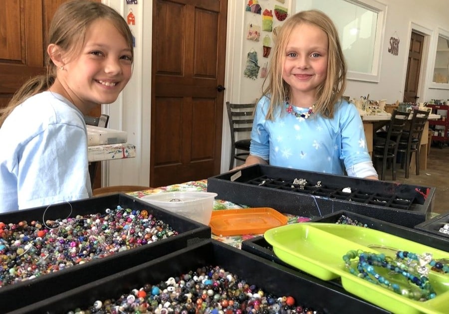 female campers working on bead project