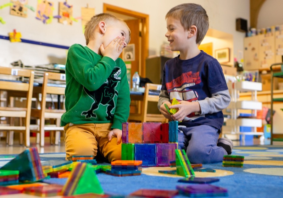two little boys playing with magnetiles