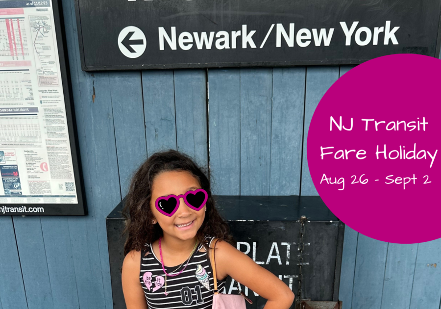 girl standing under the newark/nyc sign