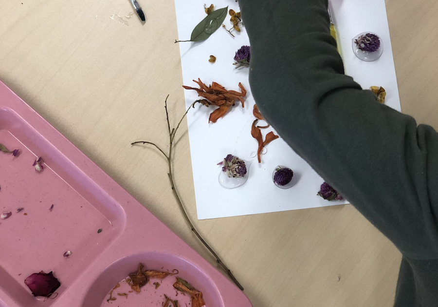 Kids Garden Child gluing leaves and making art