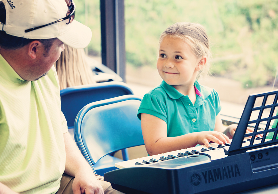 child playing keyboard in a Childrens Music Academy class
