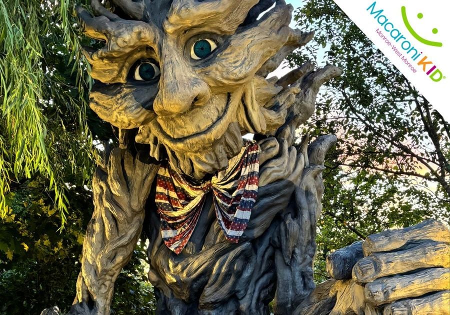 Large tree figure in the shape of a troll with a red, white, and blue tie.