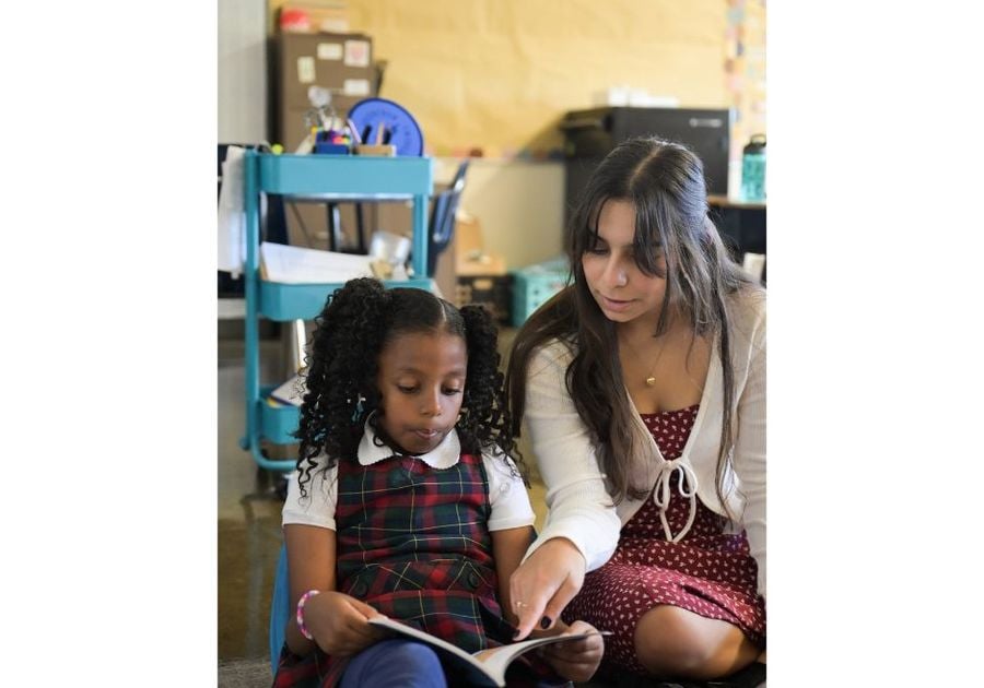 teacher reading with student