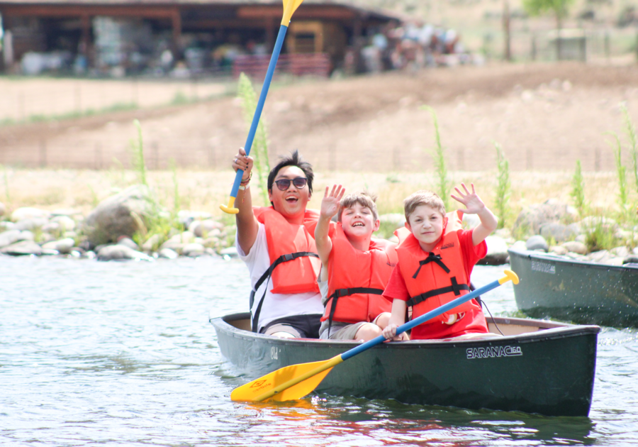 Campers and camp counselor in a canoe at Roundup River Ranch
