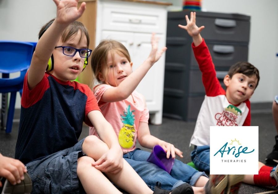 A group of children raising their hands