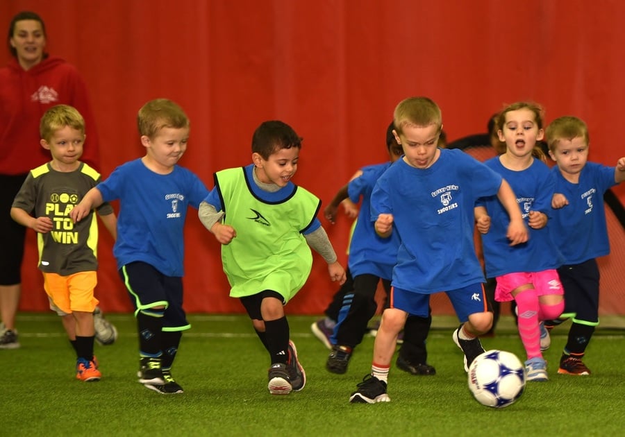 Young children playing soccer