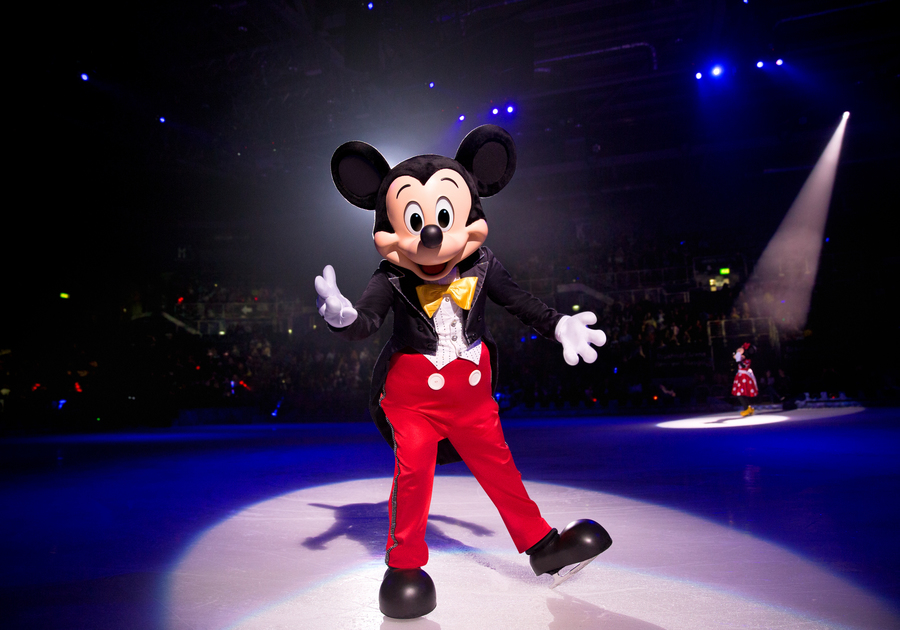 mickey mouse in the spotlight standing with ice skates