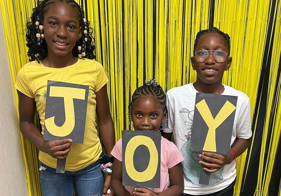 photo of young females holding up letters that spell 