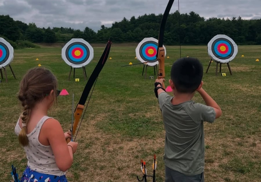 Kids shooting arrows at targets