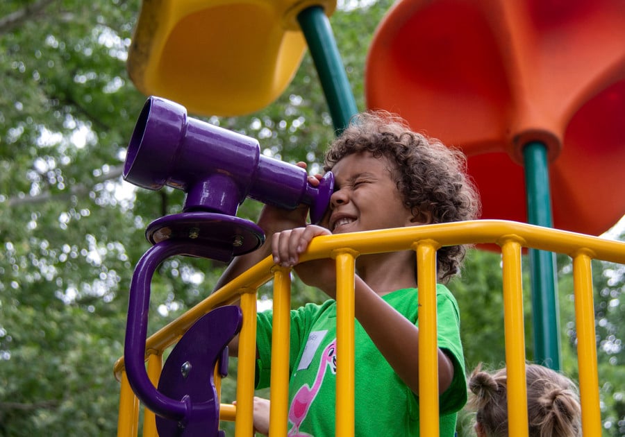 Child looking through telescope