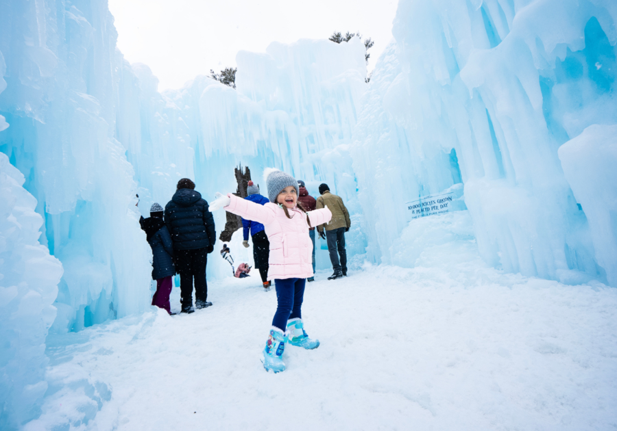 Child with family in the back inside Ice Castles