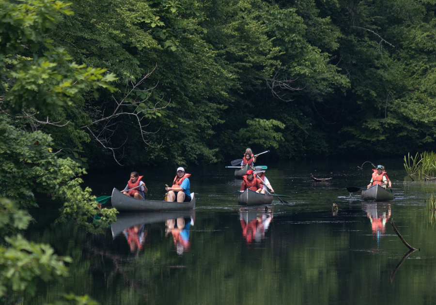 campers canoeing in river