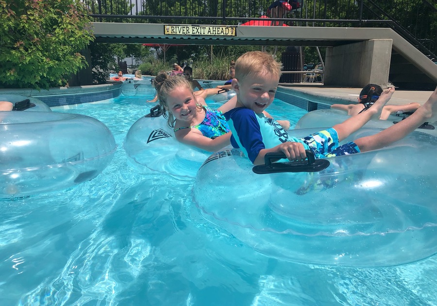 smiling children floating in lazy river at Pirates Cove Family Water Park