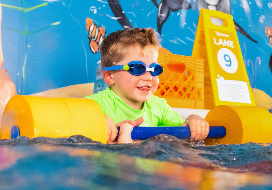 boy with googles swimming in the water