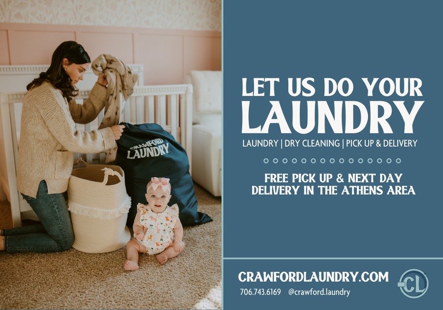 photo of mother placing laundry in bag, next to child