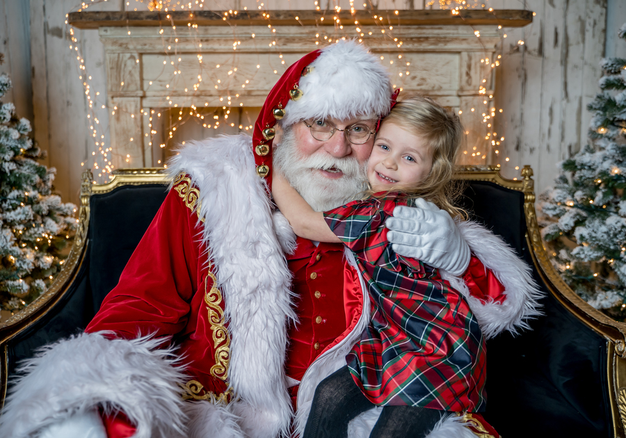 little girl hugs santa