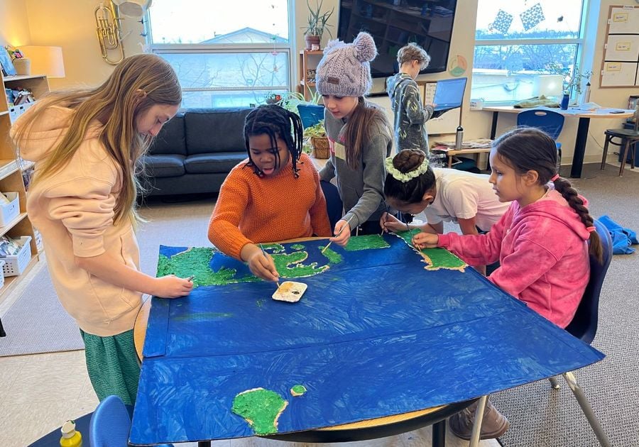 middle school girls working on a painting together