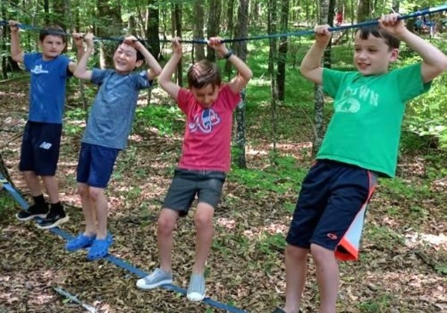 photo of campers walking along rope