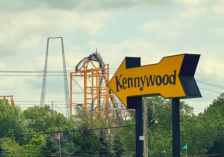 Yellow Kennywood Park sign with Pittsburgh's largest roller coaster the Steel Curtain in the background