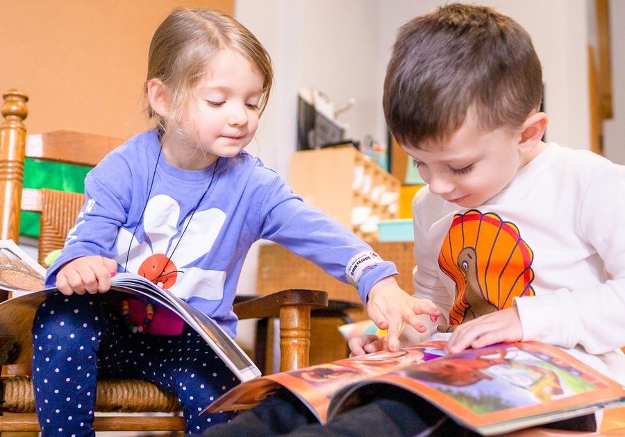 two preschoolers reading