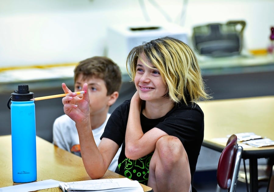 Benchmark Summer Camp  smiling students sitting at desks in a classroom