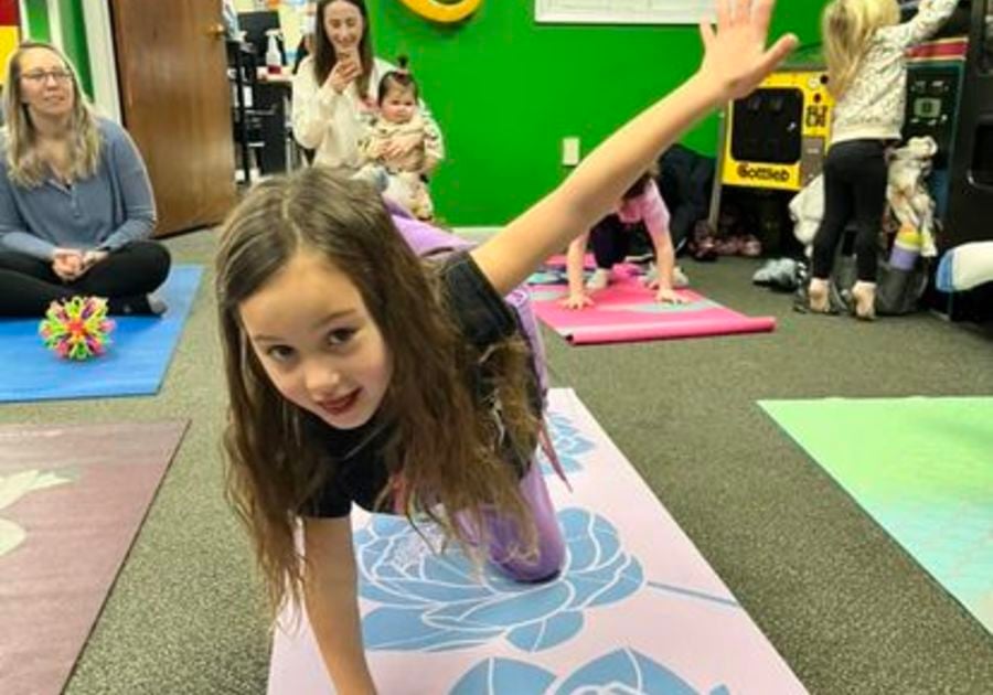 Girl smiling doing yoga pose