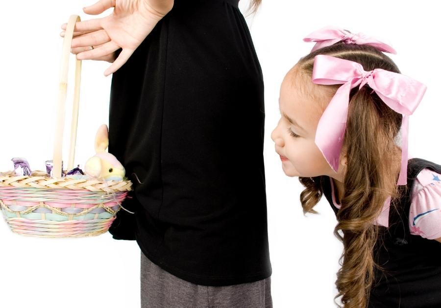 Child peeking at Easter basket