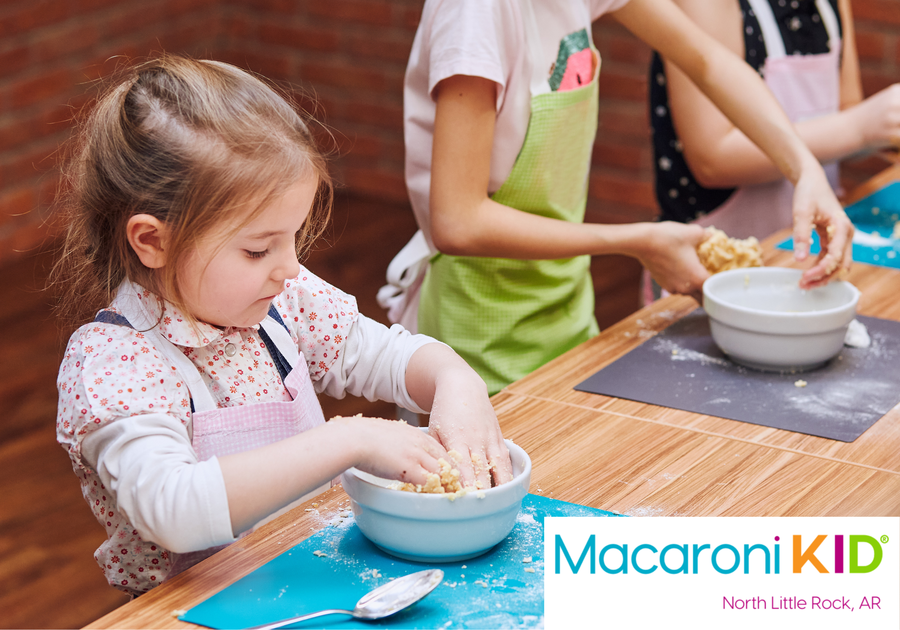 Kids taking a baking class, mixing dough in a bowl